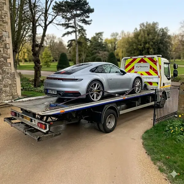 Porsche being recovered through gates of a country house near Barnes